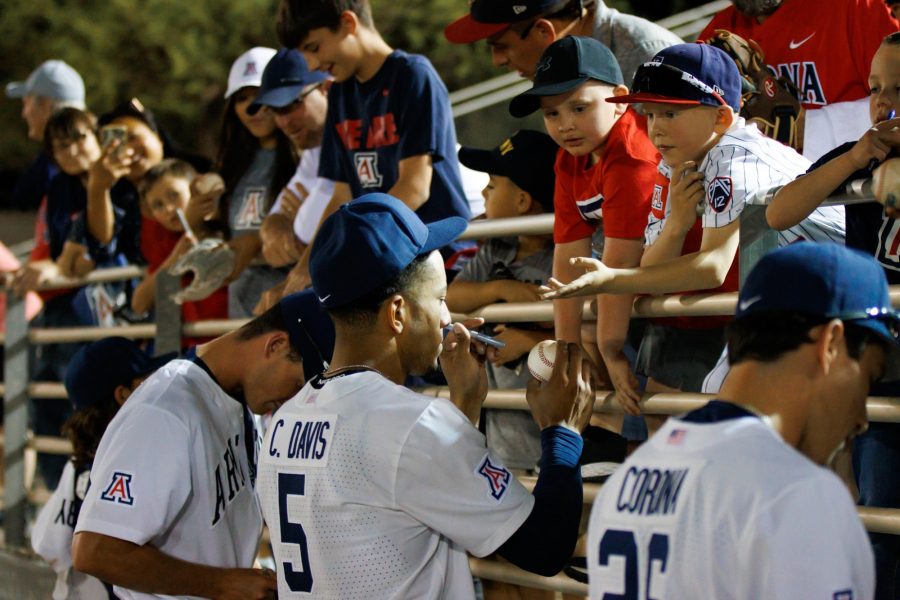 Arizonas+Chase+Davis+signs+baseballs+for+fans+after+a+game+against+New+Mexico+on+April+11+at+Hi+Corbett+Field.+The+Wildcats+went+on+to+win+the+game+14-2.%26nbsp%3B