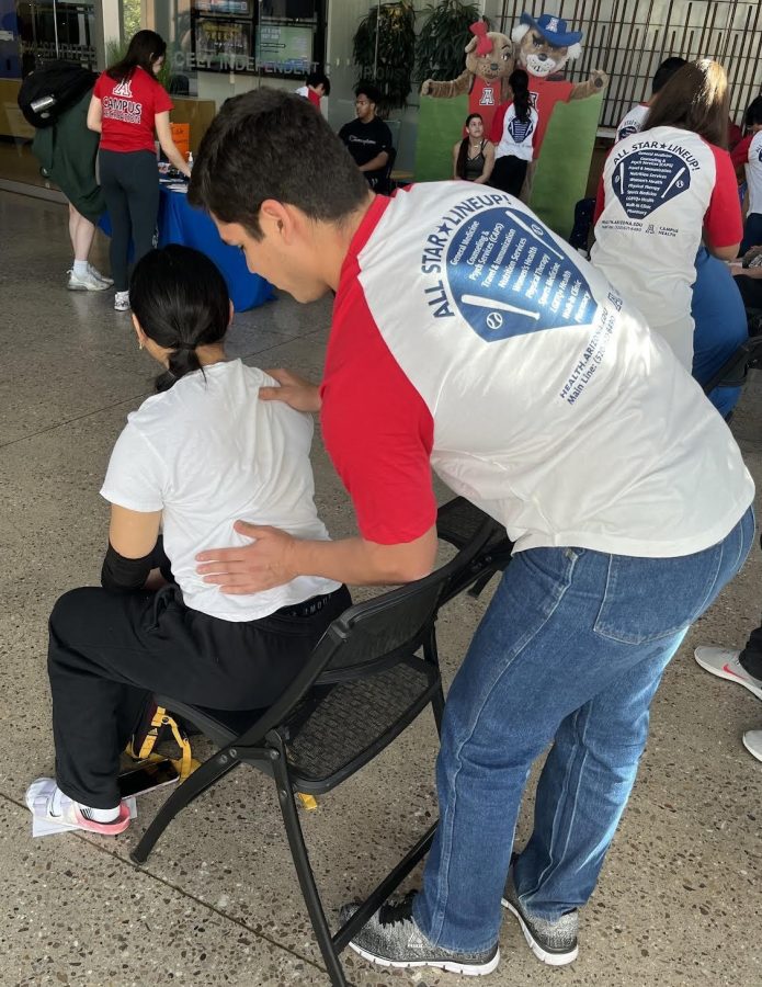 A volunteer gives a University of Arizona student a back rub at the Campus Recreation Center during a Stressbusters event. (Courtesy of Lee Ann Hamilton)