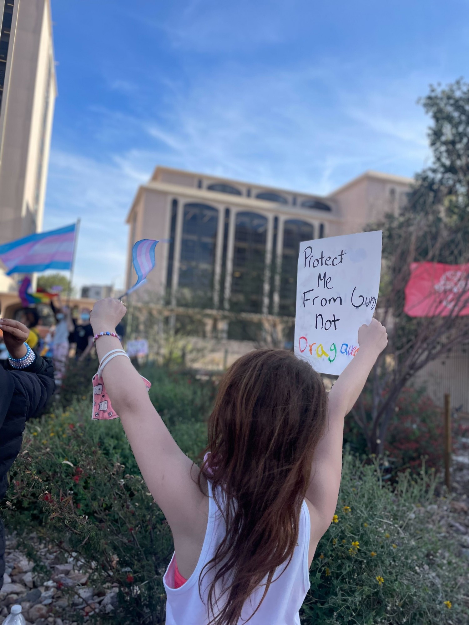 A young protestor holds up a sign that reads "protect me from guns, not drag queens" at the Trans Day of Visibility protest held March 31 in Downtown Tucson. Hundreds gathered at this event to demand action be taken by legislators to protect trans people.