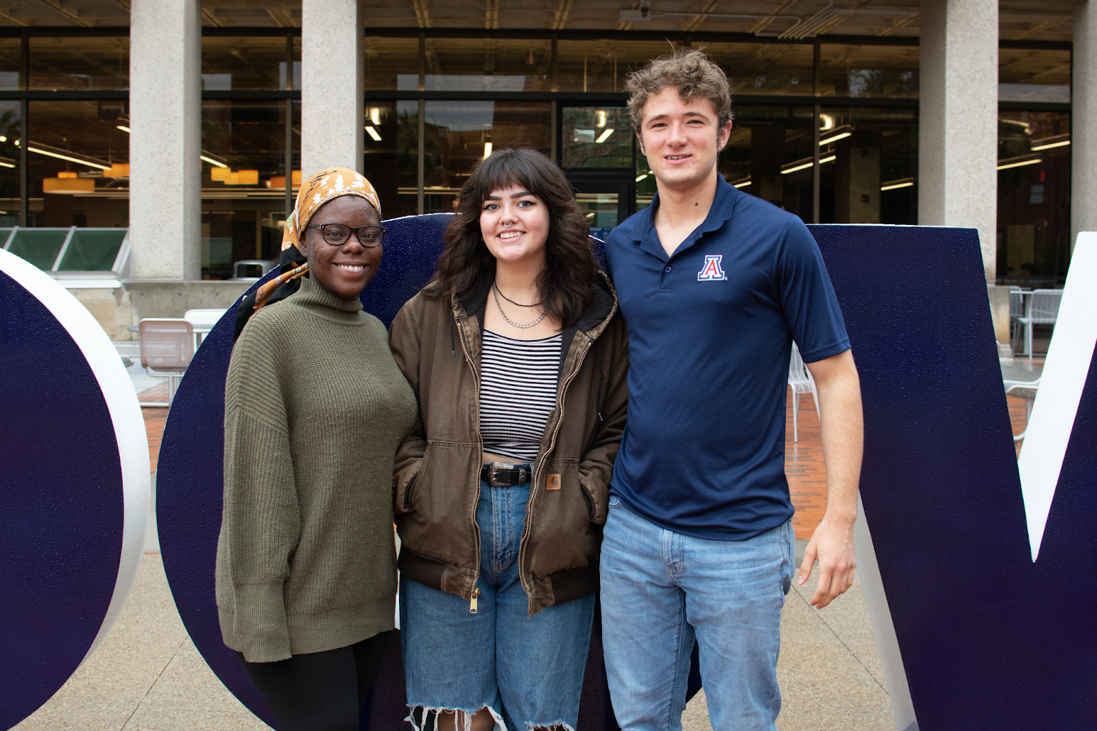 From left: Aysha Smith, Em Cuevas and Evan Laughlin 
stand in front of the University of Arizona's Main Library.
 (Courtesy of Evan Laughlin)