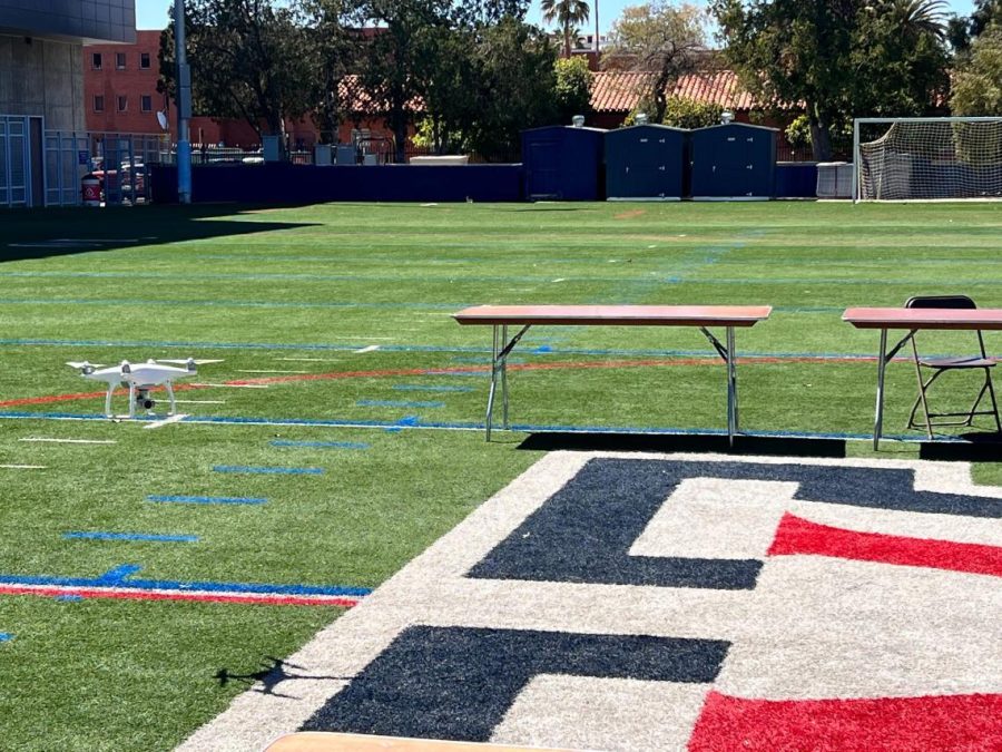 A drone flies from tables set up on Bear Down Field.
