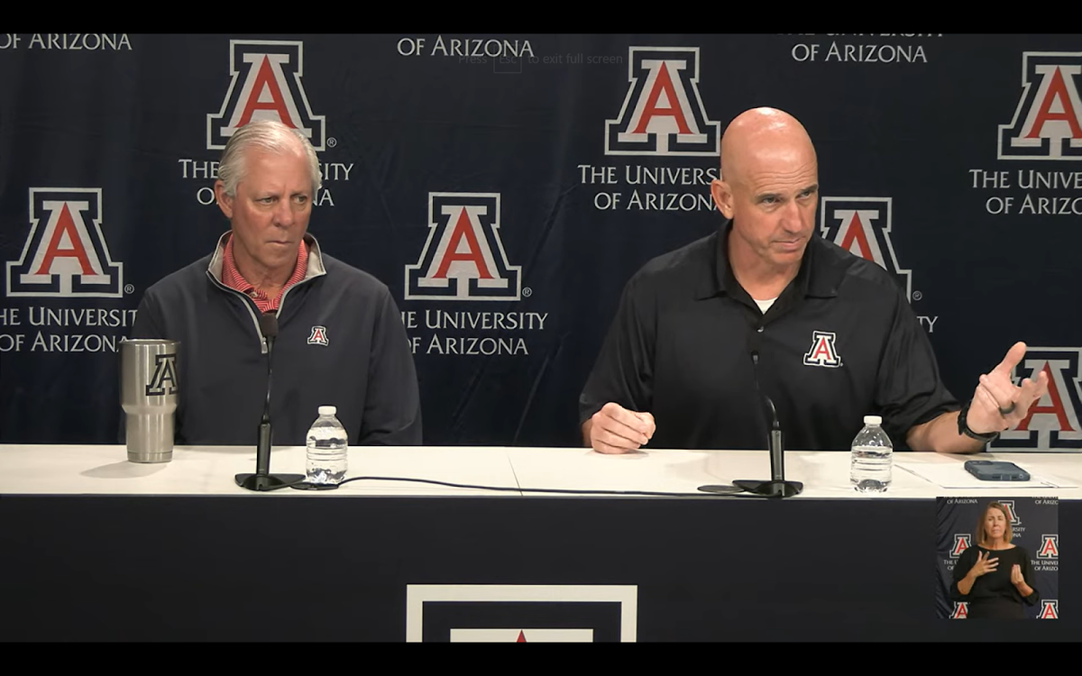 President Dr. Robert C. Robbins (left) and Chief Safety Officer Steve Patterson (right) speak at a Welcome Back briefing in McKale Center on Friday, Aug. 25. (Courtesy University of Arizona)
