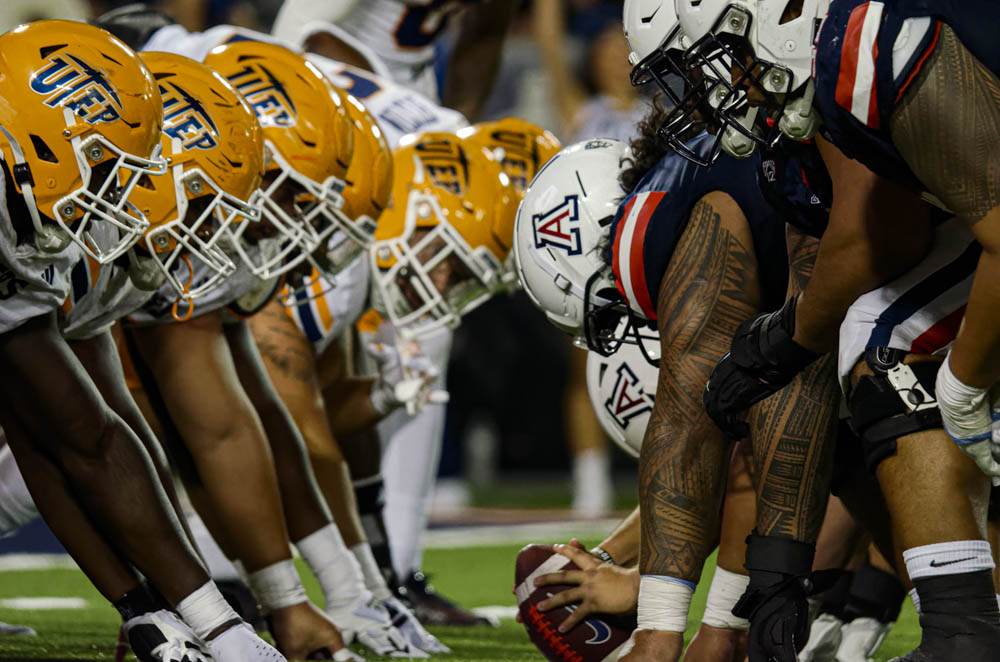 Linemen on the the Arizona and UTEP football teams prepare to start a play at Arizona Stadium on Saturday, Sept. 16. Arizona won the game 31-10.