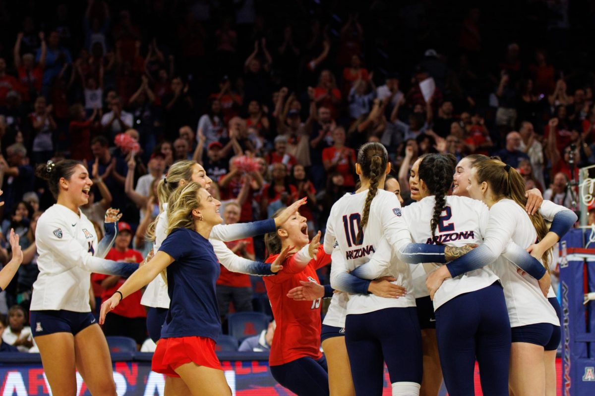 The Arizona volleyball team celebrates a win against New Mexico State on Friday, Sept. 15 at McKale Center. The Wildcats won the game 3-1.