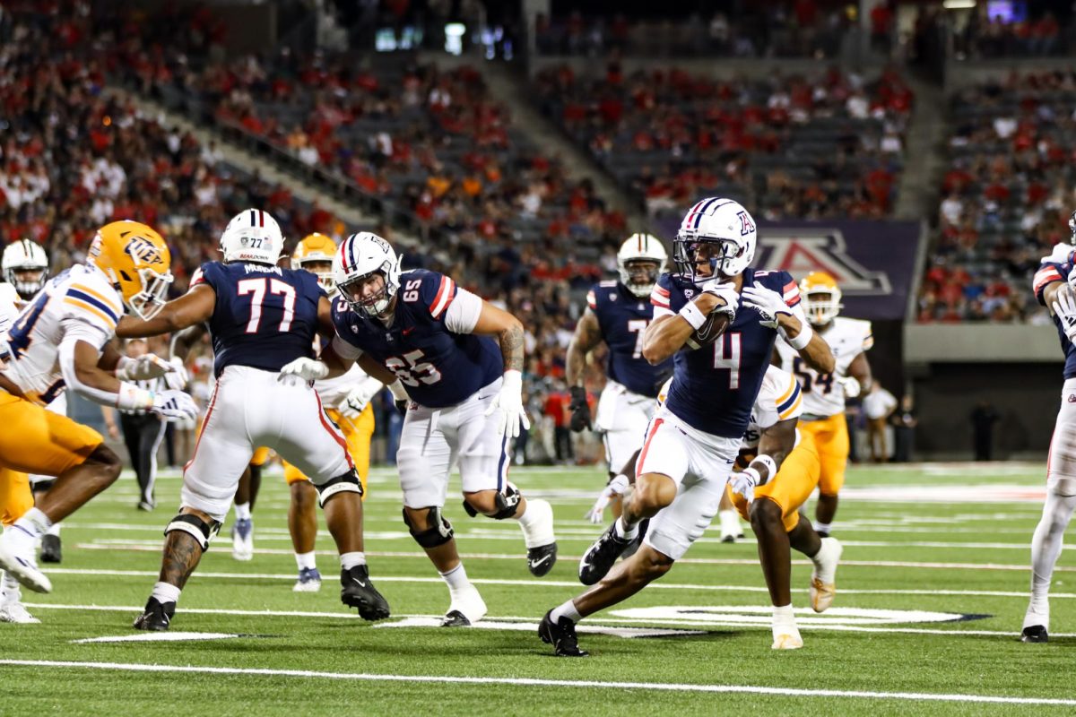 Arizona wide receiver Tetairoa McMillan (4) dodges a tackle, resulting in a touchdown against UTEP on Saturday, Sept. 16 at Arizona Stadium. The Wildcats won the game 31-10, improving to 2-1 on the season.