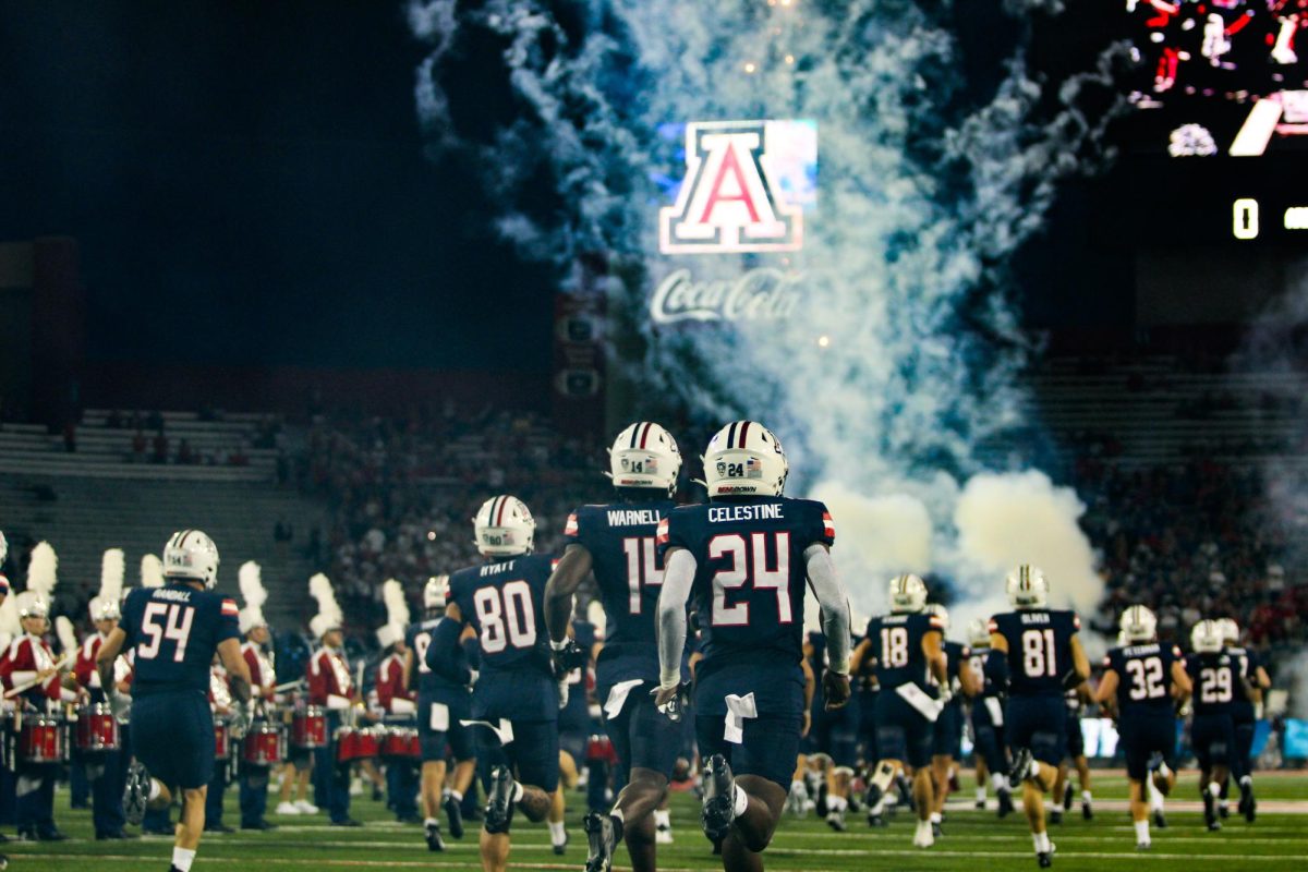 UA+football+players+make+their+way+onto+their+home+field+for+the+first+game+of+the+season+on+Saturday%2C+Sept.+2%2C+against+NAU.+The+game+was+victorious+for+the+Wildcats%2C+who+secured+a+38-3+win.