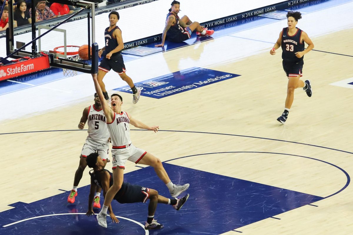 Filip+Borovicanin+runs+through+a+Lewis-Clark+State+College+defender+to+reach+the+hoop+late+in+the+first+half+in+McKale+Center+on+Friday%2C+Oct.+20.+Borovicanin+led+the+game+with+eight+total+rebounds.%0A