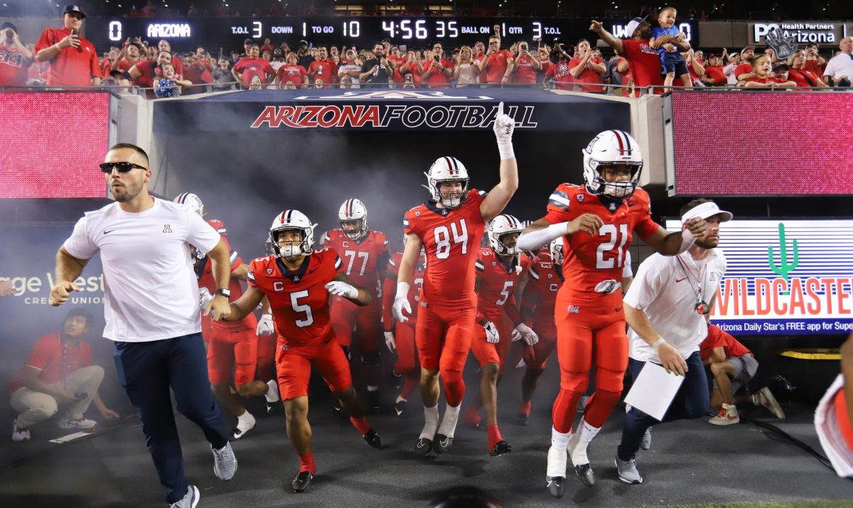 Led by tight end Tanner McLachlan (84), the Arizona football team makes its way onto the field for the sold out home game against the University og Washington in Tucson on Saturday, Sept. 30. The Wildcats lost the game 24-31.
