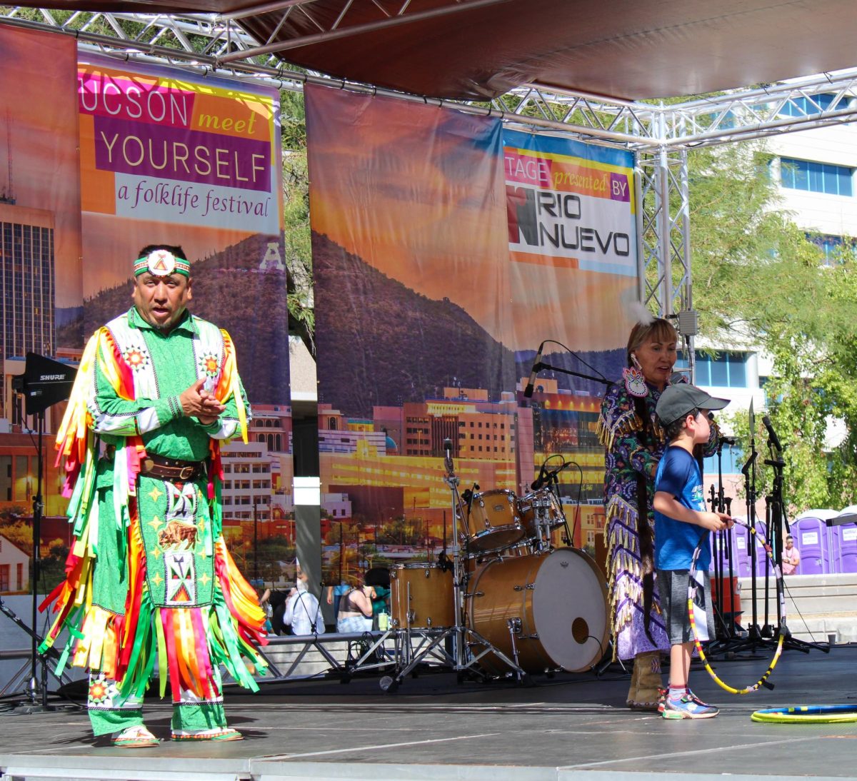 Members of the Yellow Bird Indian Dancers congratulate a young volunteer after teaching him a traditional dance on Saturday, Oct. 14, at the Tucson Meet Yourself festival in Downtown Tucson. This internationally renowned dance company shares songs, stories and dances from Apache culture.
