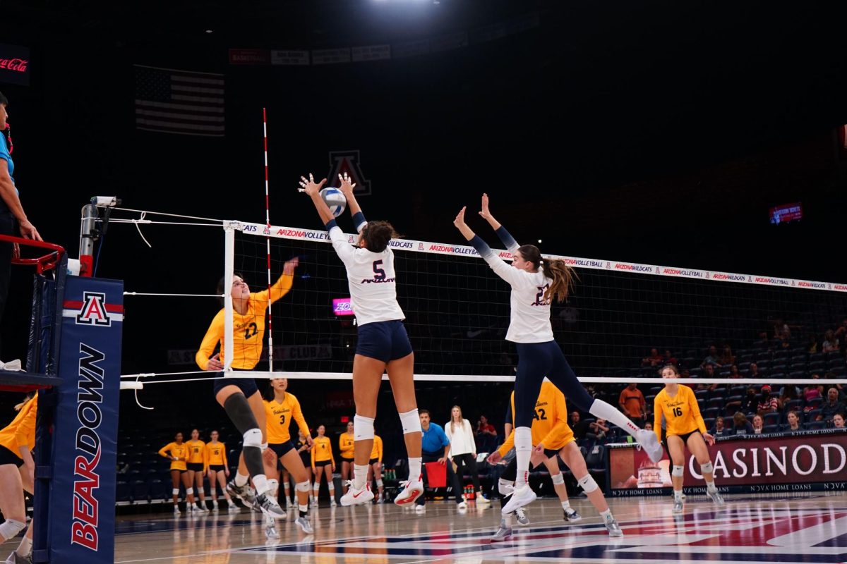 Jordan Wilson (5) blocks an attack made by the University of California Berkeley in McKale Center on Sunday, Oct. 29. Wilson contributed one of the three blocks made by the Wildcats.