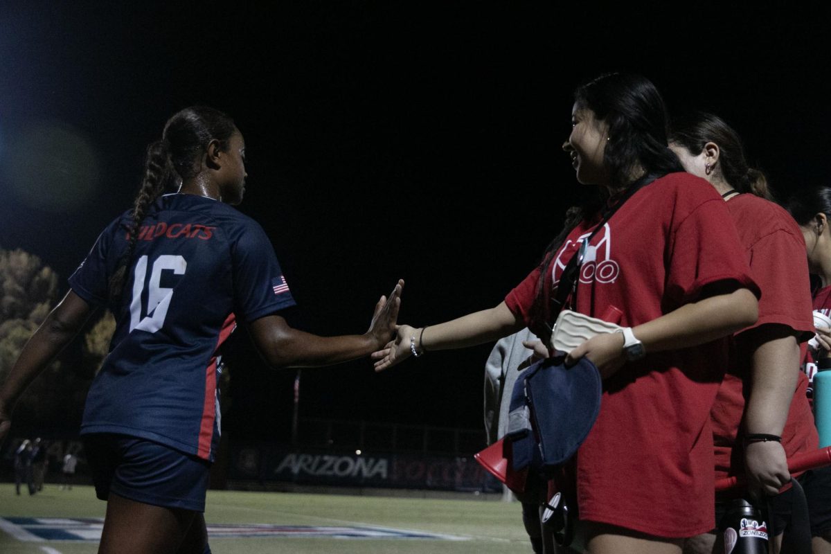 The Arizona soccer team and the ZonaZoo participants high five after the Arizona vs. UCLA game on Thursday, Oct. 19, at Murphey Field at Mulcahy Soccer Staduim. UA lost to UCLA 1-4.