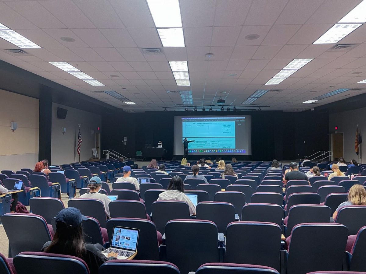 University of Arizona students wait for their psychology class to start in a lecture hall Thursday, March 31, 2022. After years of having more leniency with attendance due to the pandemic, some UA professors are starting to switch back to pre-pandemic standards.