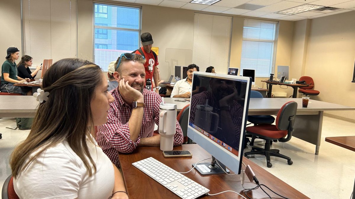 Professor Michael McKisson helps out his student Olivia Laine in the Louise Foucar Marshall Building on Oct. 18. Olivia and fellow students were working with Adobe Premiere Pro.