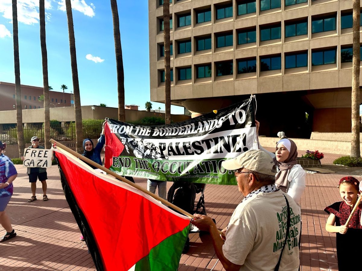 Protesters hold up signs in support of Palestine at a downtown rally in Tucson on Monday, Oct. 9. The event was organized as a reaction to the Israel-Hamas war. (Liv Leonard, El Inde Arizona)