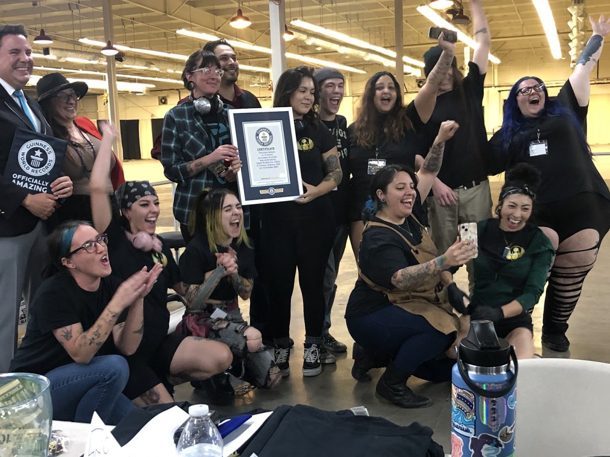 The group of Spark Project artists with Johnny Vasquez, Yvette Madison and adjudicator Michael Empric celebrate after the announcement that they beat the world record on Friday, Oct. 13, in Tucson at the Tucson Expo Center.