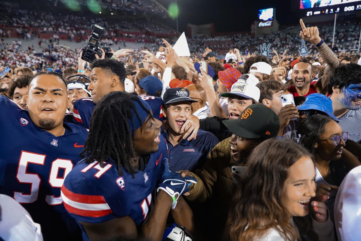 Fans congratulate Arizona football safety DJ Warnell Jr. (14) after Arizona beat No. 20 UCLA 27-10 in the Homecoming football game. Warnell Jr. transferred to Arizona from UCLA earlier in his career.