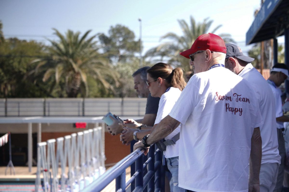 Lance Johnson supports his granddaughter for UA swim on Nov.4 at Hillenbrand Aquatic Center. UA had a swim and dive meet against UCLA.