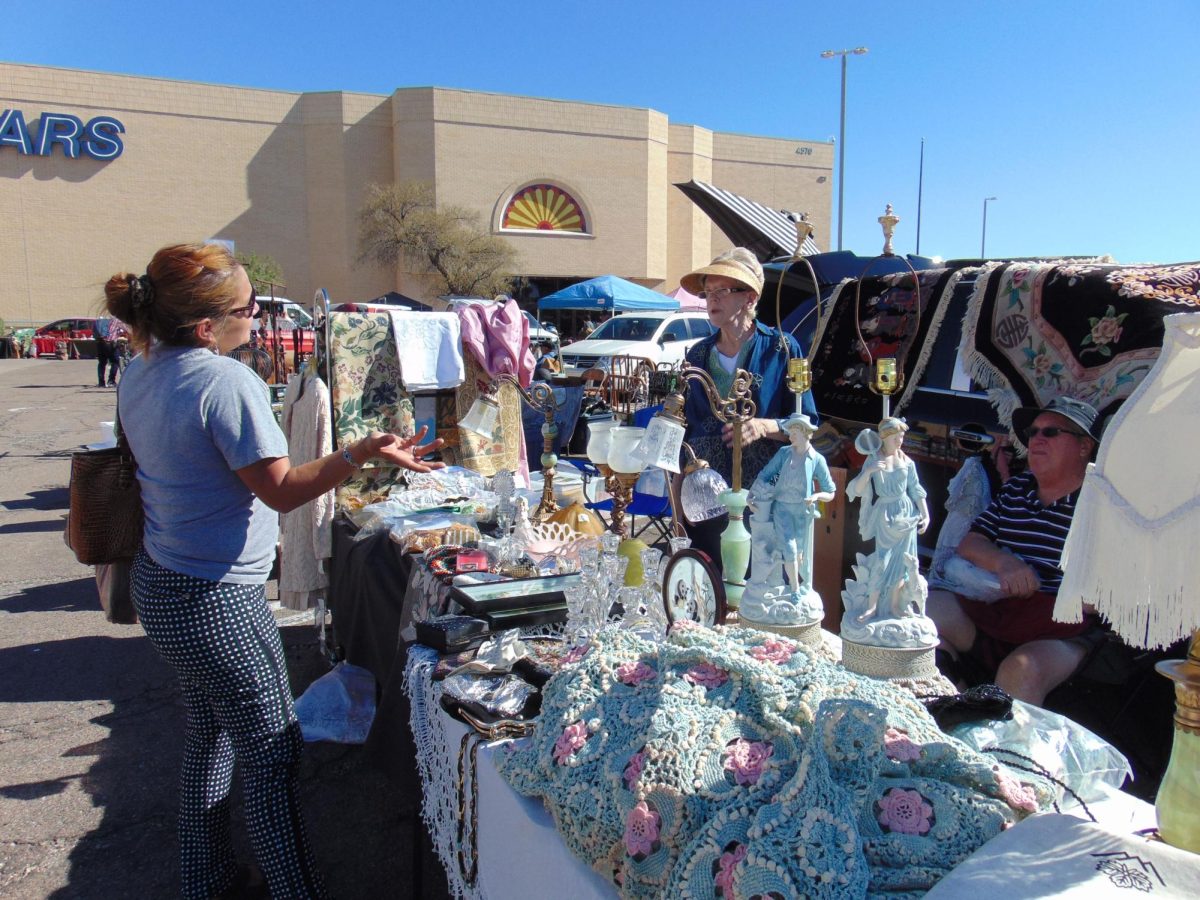 Deals are made between shoppers and vendors at the 2nd Sunday Vintage Market located on Oracle Road on Nov. 12. Clothing items, home furnishing and more were sold.
