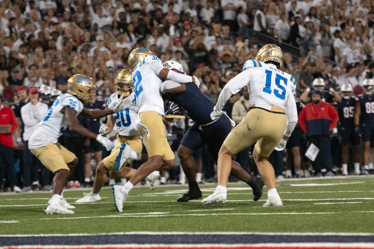 Quarterback Jayden de Laura of the Wildcats rushes the Bruins Defense during the football game at Arizona Stadium in Tucson on Nov. 4. The Bruins line would hold and the touchdown would be made by Jacob Cowing.
