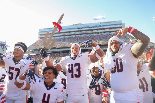 Dalton Johnson and the team pose with Arizonas turnover sword after intercepting the ball from Arizona State during the 2023 Territorial Cup in Tempe, Arizona.  Arizona has now won the Cup two years in a row.