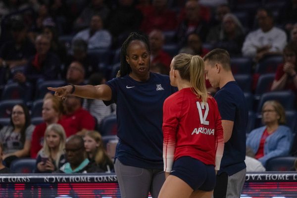 Arizona volleyball head coach Charita Stubbs talks to player Joy Galles (12) during the game against the University of Utah on Thursday, Nov. 9, in McKale Center. The Wildcats went on to win the game 3-1.