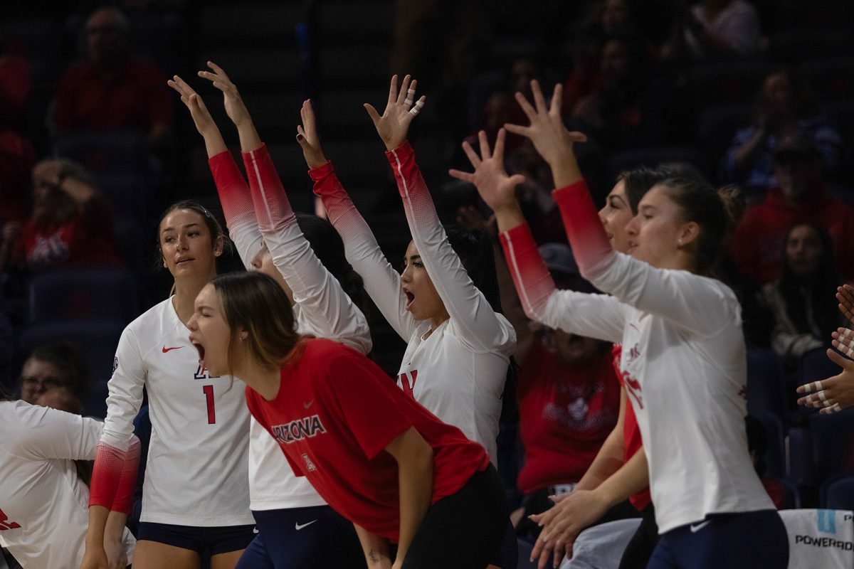 The Arizona volleyball team cheers after a teammate scored a point against the University of Utah in the first set on Thursday, Nov. 9, in McKale Center. The Wildcats went on to win the game against Utah 3-1.