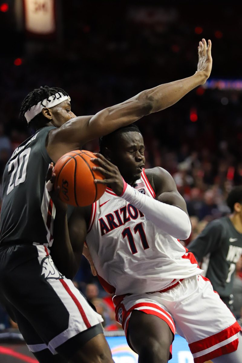 Arizonas Pelle Larsson fights for a rebound with Washington State defender Rueben Chinyelu in McKale Center on Feb 22. Arizonas loss to Washington State marks the first home loss in nearly a year since Arizona State.
