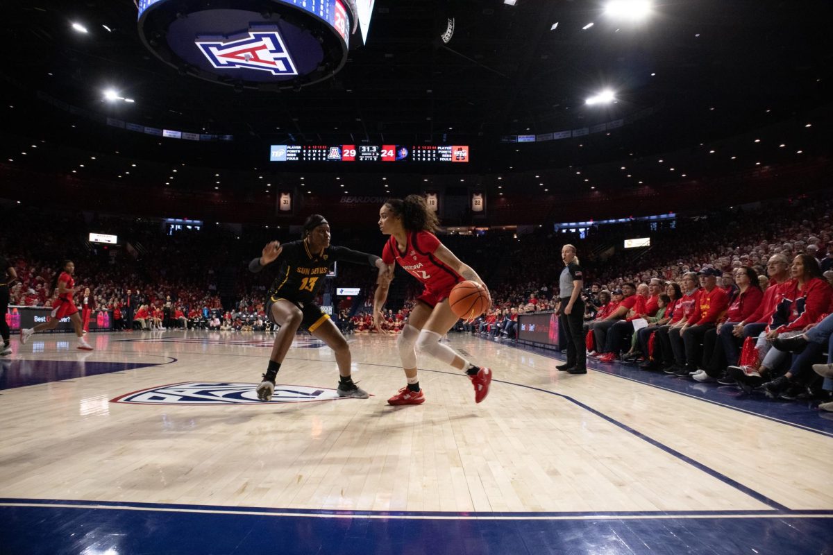 Sandra Magolico (13) of the Sun Devils guards forward Esmery Martinez (12) of the Arizona Wildcats during their game in McKale Center on Feb. 4. The Wildcats entered the second half of the game with a seven point lead.
