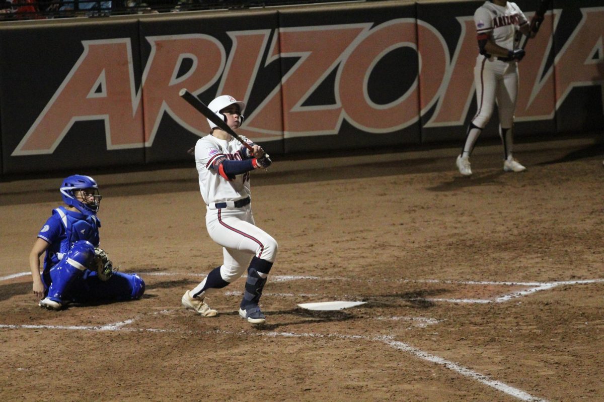 Arizonas Olivia DiNardo hits a home-run in the fifth inning at the Hillenbrand Invitational against Drake on Feb. 22. DiNardo. hits her home run right after Carlie Scupin hit one, putting The Wildcats up 4-0.