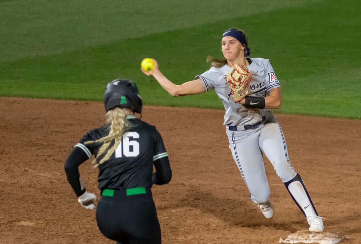 Arizona softball player Tayler Biehl throws to first to turn a double play on Friday Feb. 9, at Mike Candrea field at Rita Hillenbrand stadium. Arizona went on to sweep the Candrea Classic winning all 5 of their games by mercy rules. 