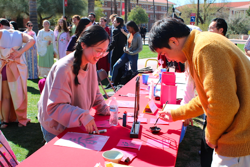 Students practice Chinese calligraphy at the East Asian Language and Culture Festival held Feb.15 on the UA Mall. 
