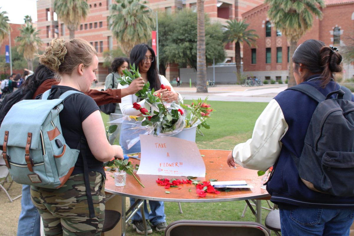 Students pick flowers to make bouquets at the Self-Care Fair on the UA Mall on March 25. The event was curated by student groups and clubs involving health on campus.