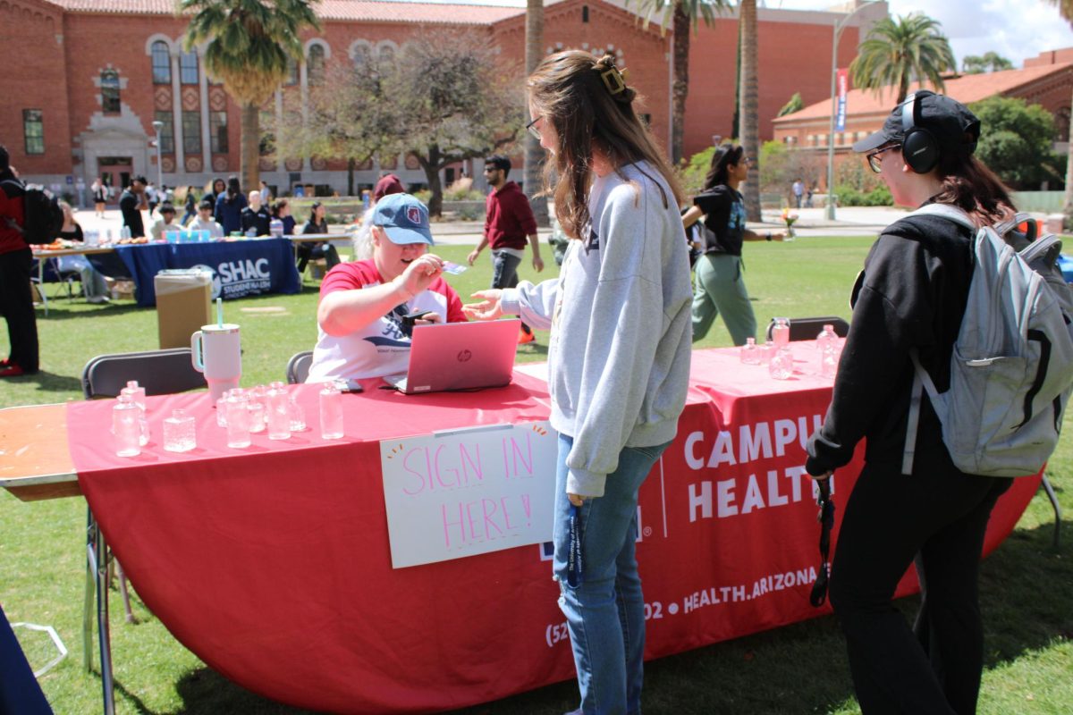 Students sign into the Self-Care Fair on the UA Mall on March 25. The fair was a student organized event promoting mental, physical and emotional health whilst being a college student.