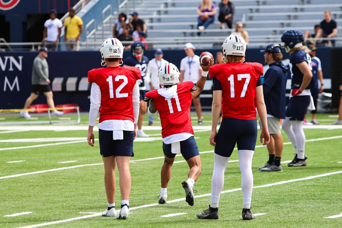 Noah Fifita passes the ball in a drill at Arizona Stadium on March 30 as backup QBs Cole Tannenbaum and Brayden Dorman watch on. The team will play their Red and Blue Spring Game on April 27.
