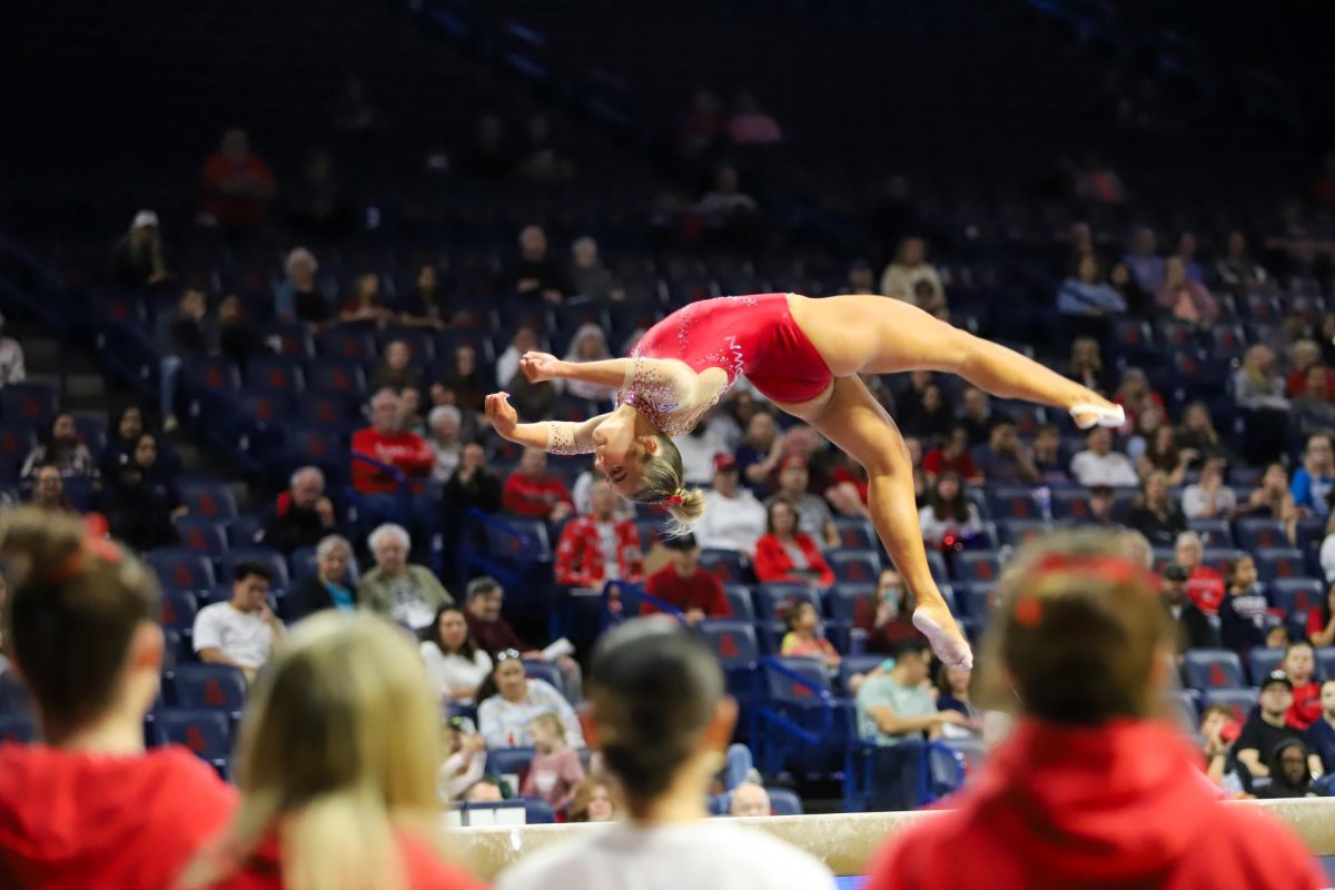 The+Arizona+Gymcats+watch+on+as+their+teammate+performs+her+beam+routine+in+McKale+Center+for+the+final+time+this+season+on+March+13.+Arizona+won+the+meet+by+beating+Southern+Connecticut+State+by+over+three+points.%0A