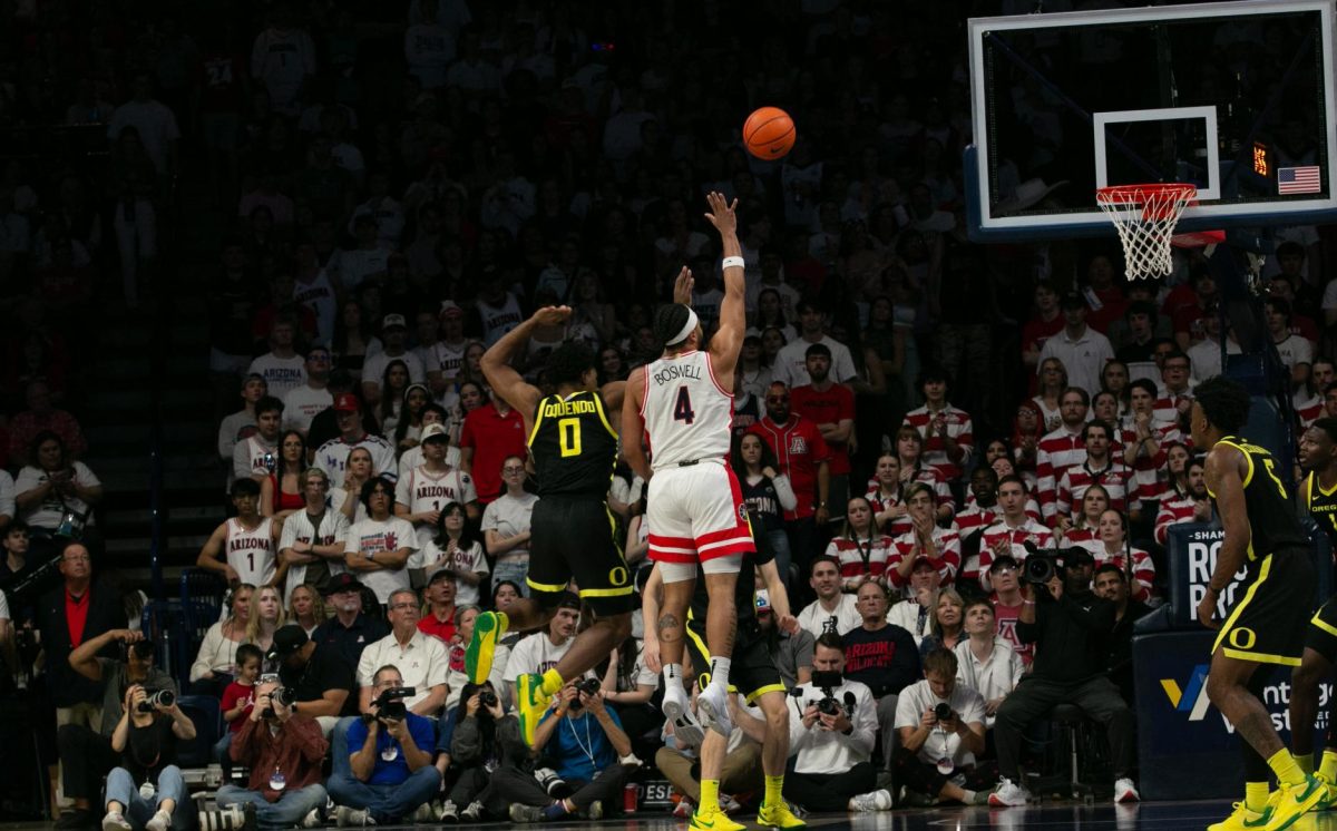 Kylan Boswell of the Arizona Wildcats hangs in the air after making a shot against the Oregon Ducks in McKale Center on March 2. The Wildcats led, entering the second half 51-30.
