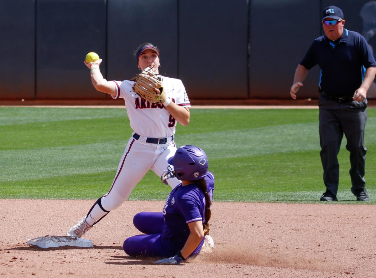 Second baseman Allie Skaggs catches a ball from the short stop and tries to turn two as she makes the throw to first base on March 17 at Rita Hillenbrand Stadium. The Wildcats beat No. 8 ranked University of Washington 2-0. 