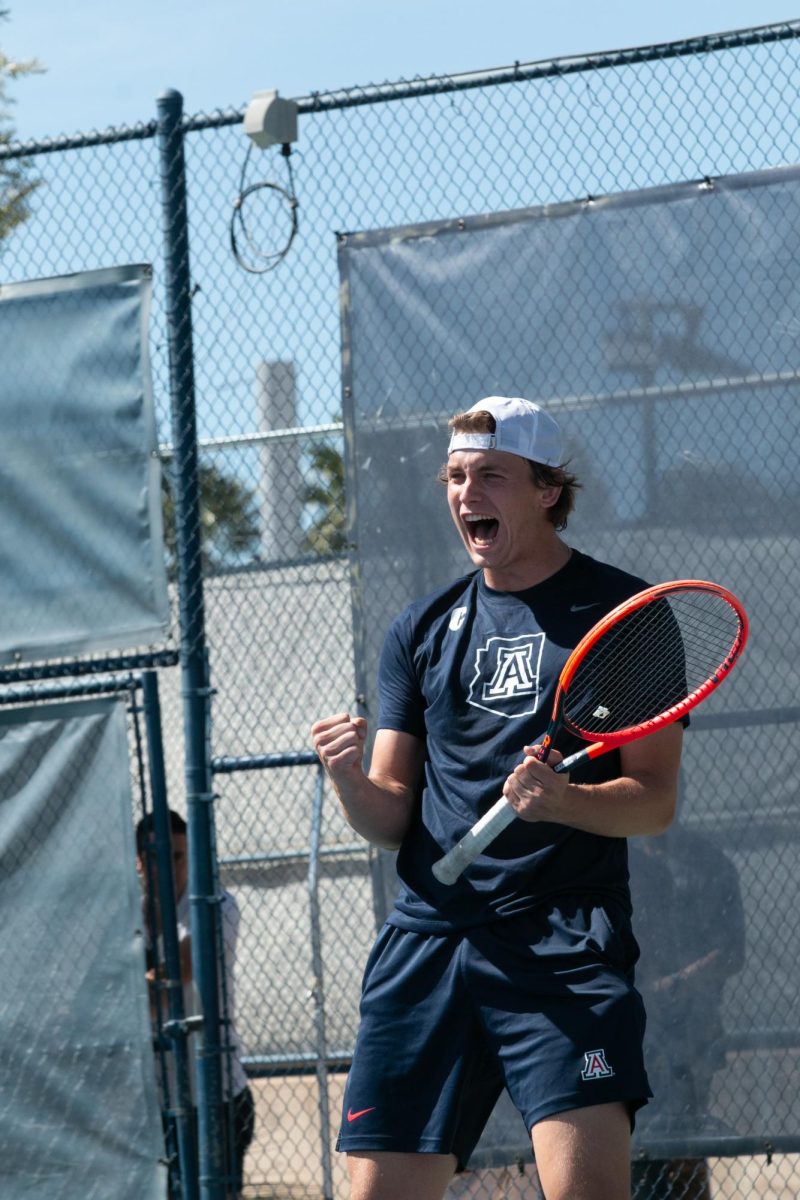 An Arizona tennis player celebrates his pair’s win over an ASU pair on April 7 at Robson Tennis Center. The first set of matches was dominated by doubles before fanning out into singles matches for the rest of the day.