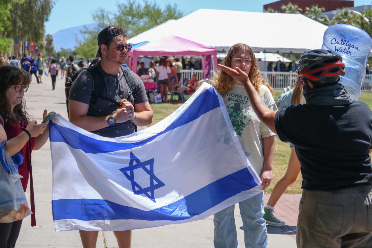 Pro-Israel protesters are silenced by a Pro-Palestine protester on the UA Mall on April 29. A Pro-Palestine protest began in the morning with tents and blankets set up.
