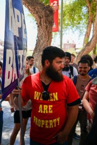 Students surround UA graduate Dean Frederick Saxton — also known as Brother Dean — on campus on April 22. Dean preached his controversial beliefs from morning until late afternoon.