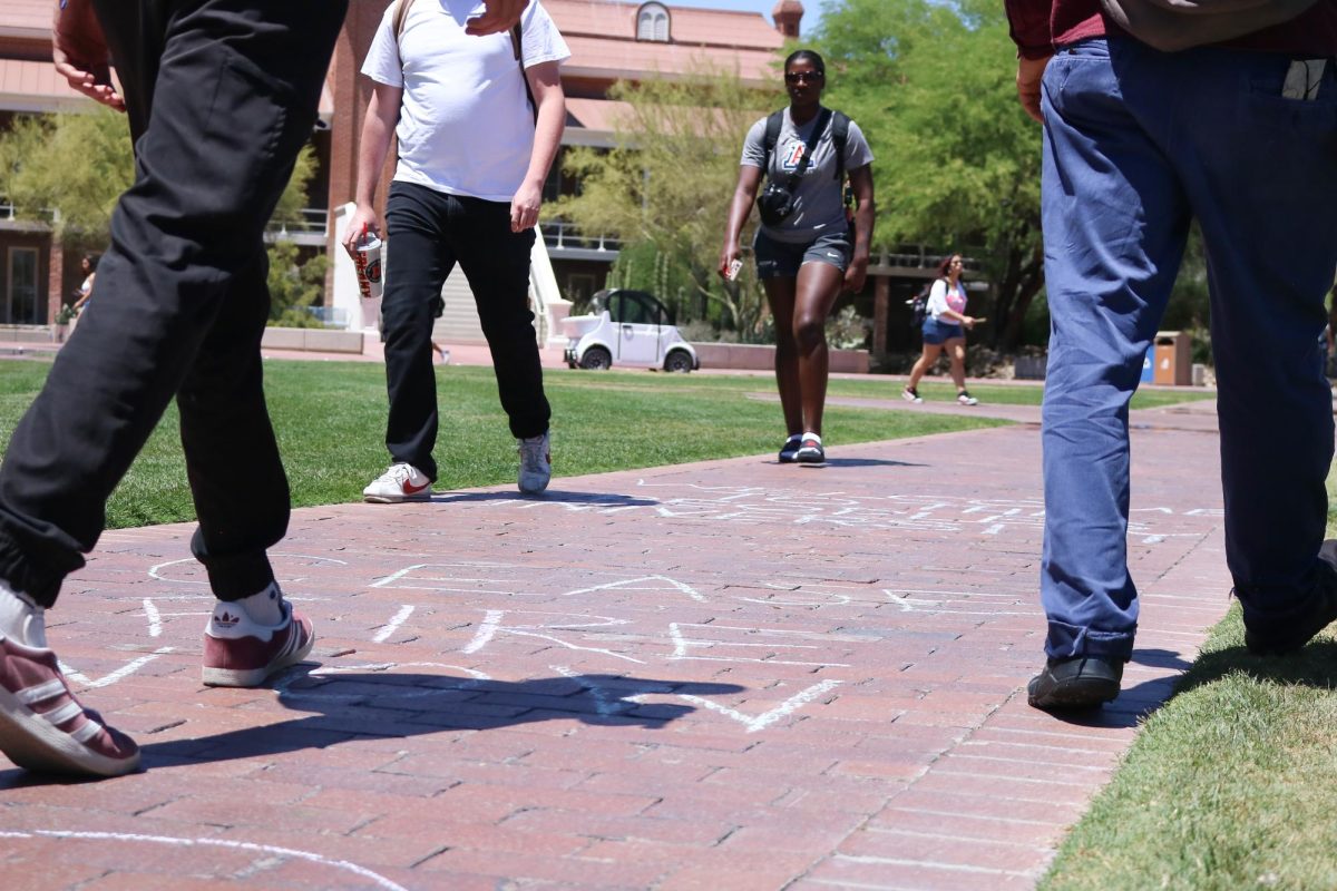 Students walk along the mall where pro-Palestine messages are written in chalk on April 29. “Free Gaza” and “Cease fire now” were among these messages.
