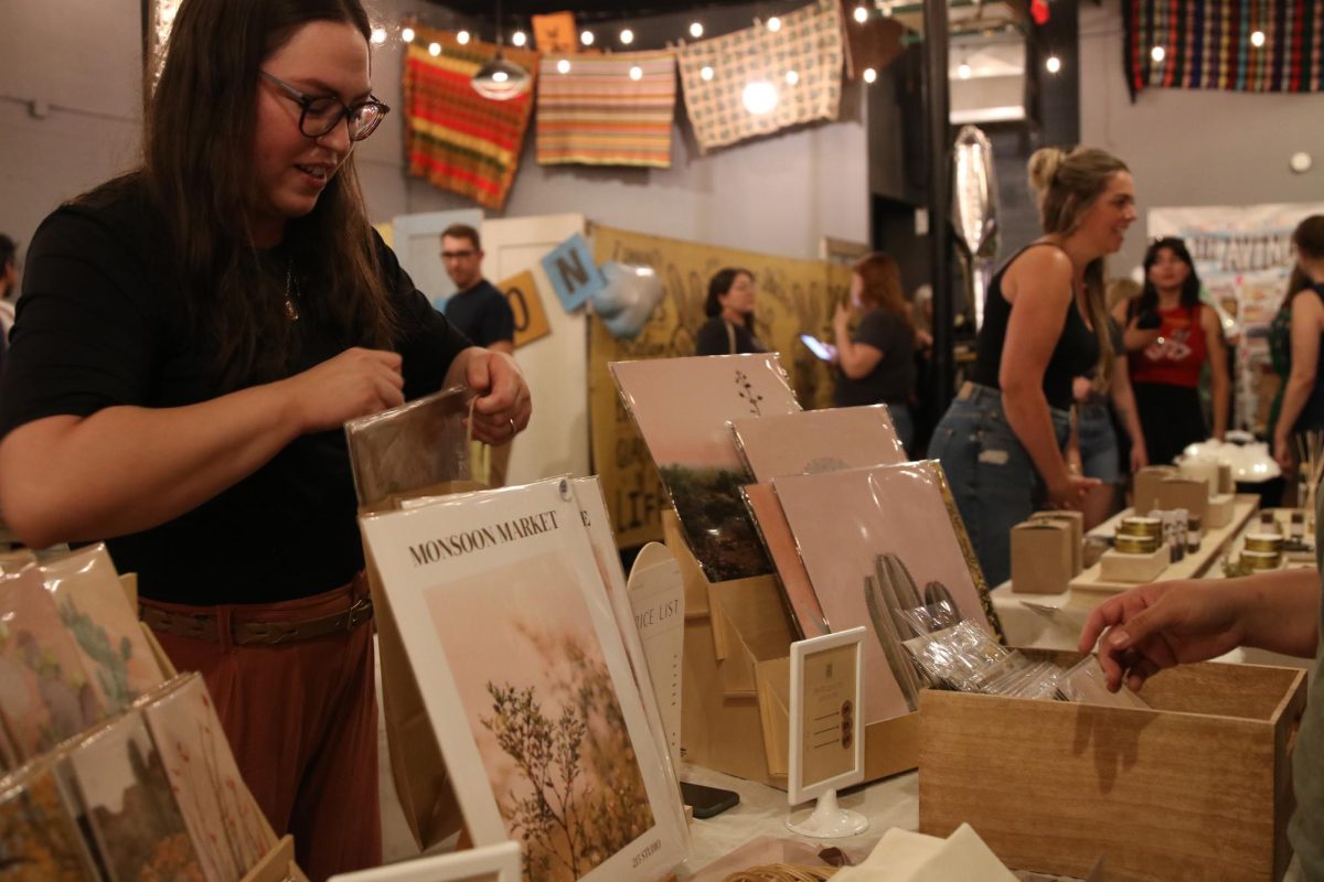 A vendor packs up goods for a customer at This is Tucsons Monsoon Market in Downtown Tucson on June 15. Local artists, jewelers and craftspeople sold their creations.