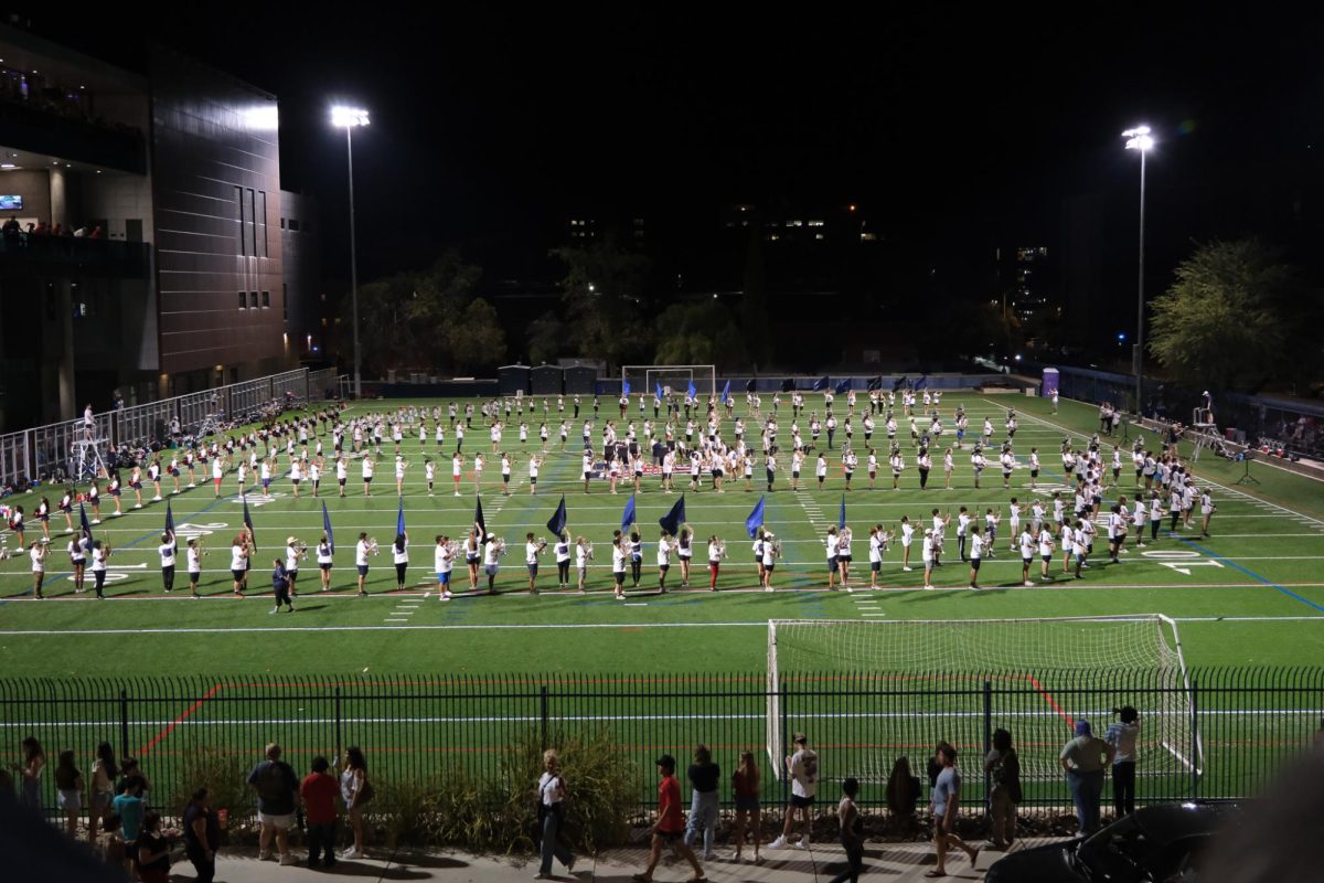 Spectators watch as the Pride of Arizona performs at Bear Down Field on Aug. 23. Ahead of football season, the band has spent time rehearsing their careful movements.