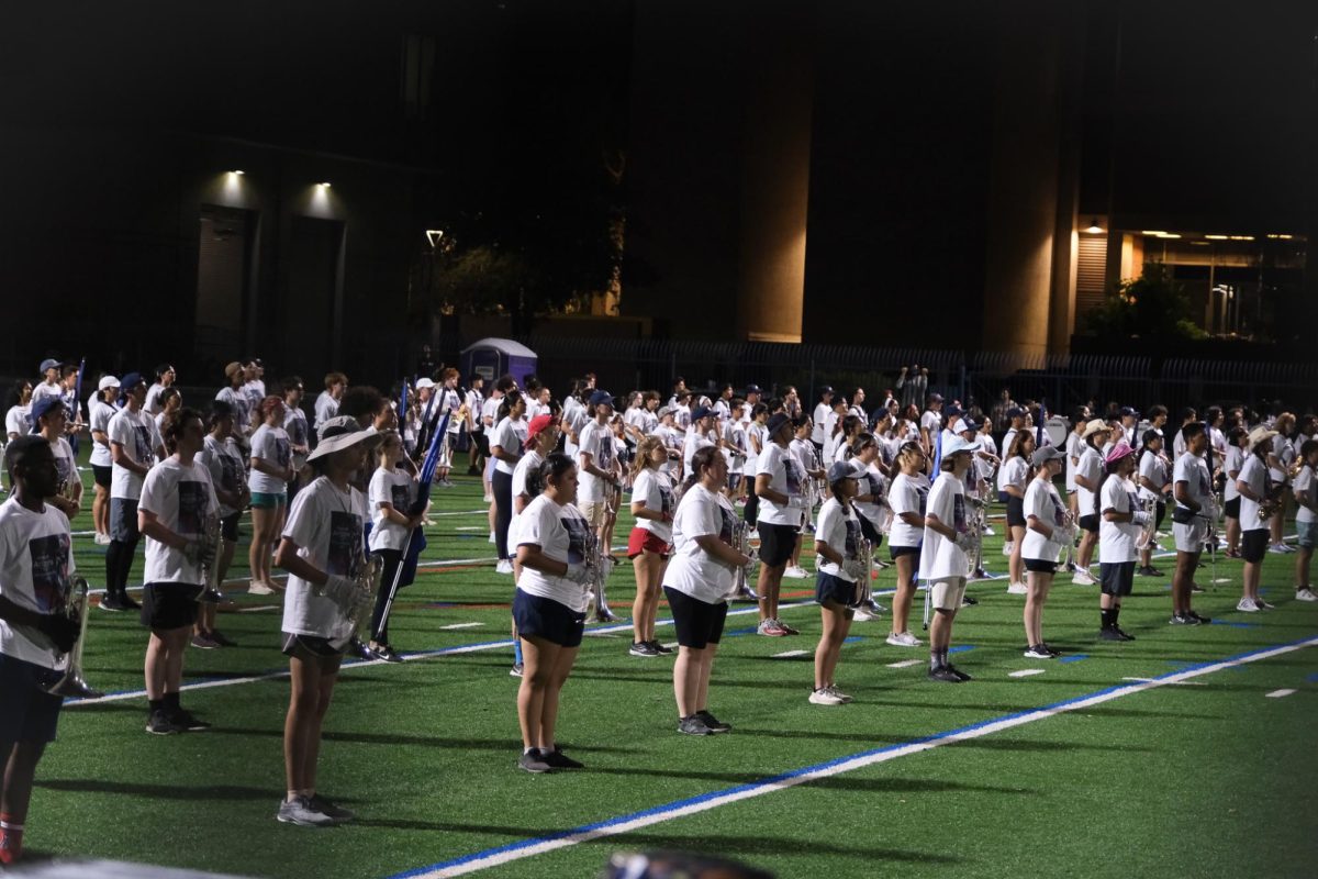 Standing in their ranks the Pride of Arizona practices at Bear Down Field on Aug. 23. Spectators stood on the sidelines and the top of parking garages to watch the band perform.