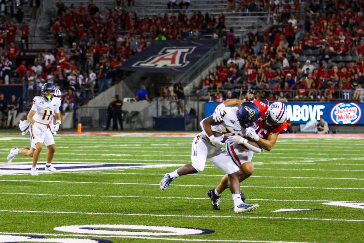 Arizona linebacker Taye Brown tackles a Northern Arizona player during a game at Arizona Stadium on Sept. 7. Wildcats walked away with the win, winning 22-10.