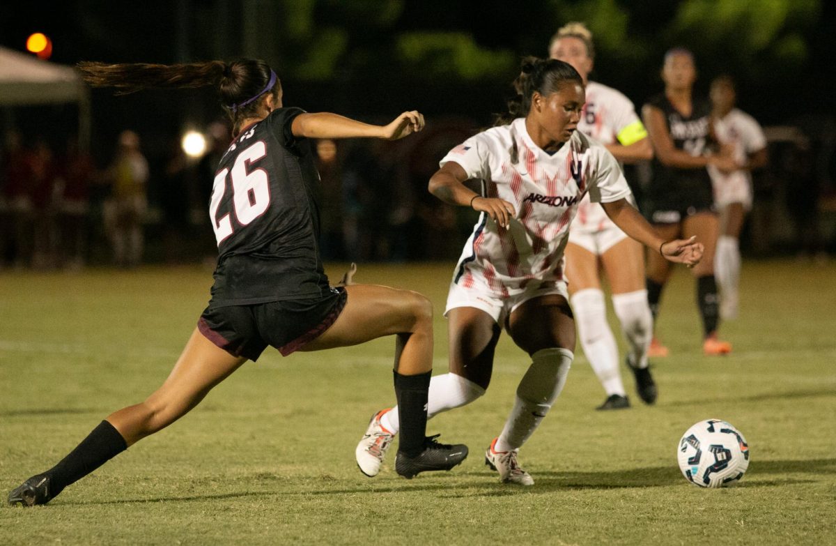 Arizona defender Zoe Mendiola goes head-to-head with New Mexico State player Milana Eyrich in the game against NMSU on Sept. 5 on Murphey Field. Arizona won in a 1-0 victory over the Aggies.