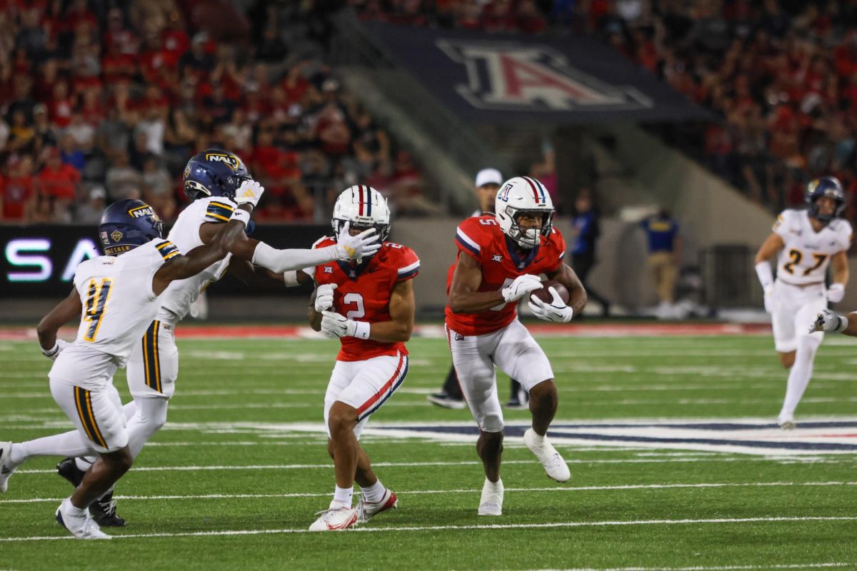 Arizona wide receiver, Montana Lemonious-Craig (5), drives down the field with coverage from defensive back, Treydan Stukes (2), against Northern Arizona University at Arizona Stadium on Sept. 7. The former Colorado player is entering his second season with the Wildcats.