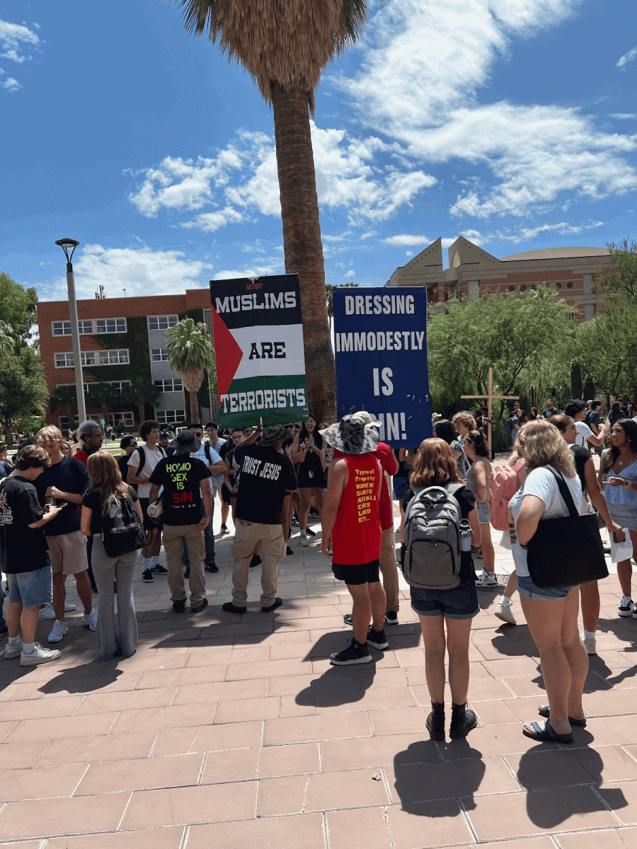 University of Arizona students gather around and converse with demonstrators outside the Administration Building on the first day of classes, Monday, Aug. 26, 2024. The demonstrators attracted attention throughout the day. (Photo courtesy of Jose Lara-Munoz)