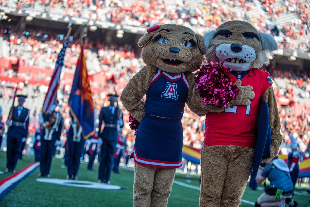 Wilma and Wilbur Wildcat pose while the national anthem plays on Oct. 26 at Arizona Stadium. They set the stage before kick-off.