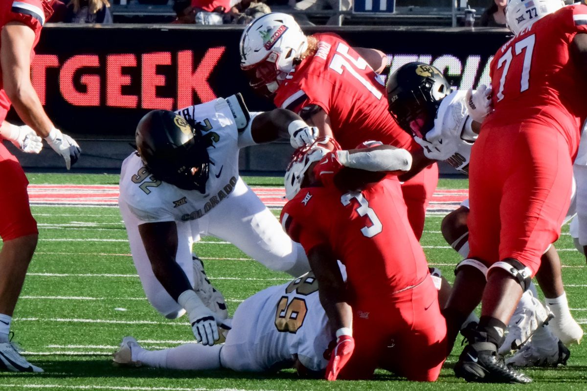 Colorado defensive tackle Anquin Barnes Jr. pulls Arizona football player Kedrick Reescano’s face mask during the Wildcat’s game against the Buffaloes at Arizona Stadium on Oct. 19. Arizona’s offense found itself stonewalled against the Colorado defense.